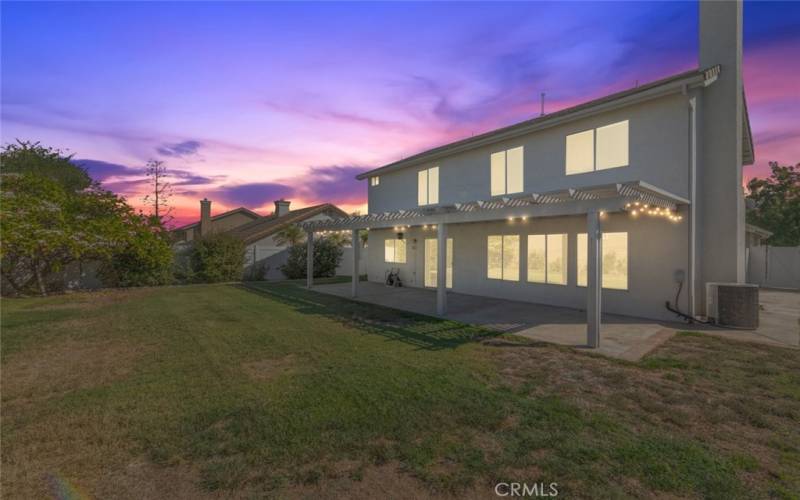 Spacious backyard with a charming patio cover, perfect for entertaining.