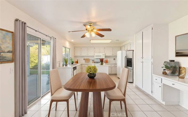 Kitchen is bright and spacious with tons of cabinetry, an island, and convenient access to the backyard patio