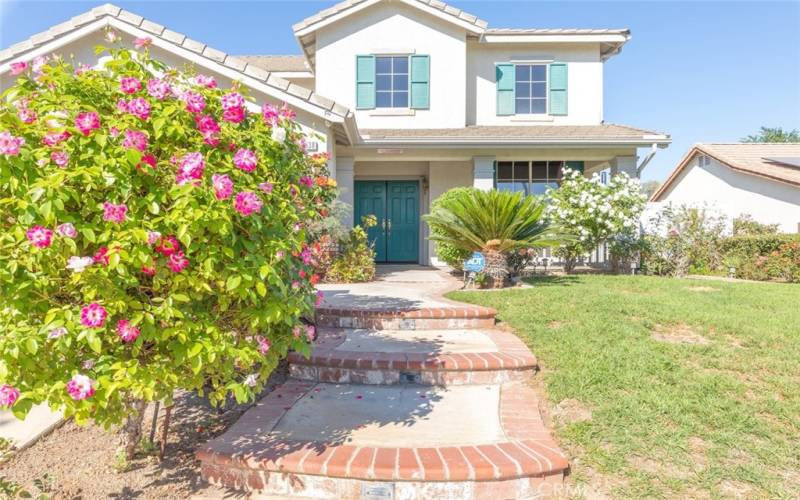 Charming brick-accented walkway leading to an inviting front door.