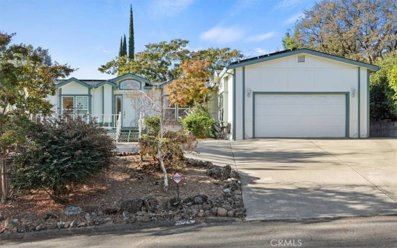 Two car garage, parking on the driveway and additional parking area adjacent to driveway