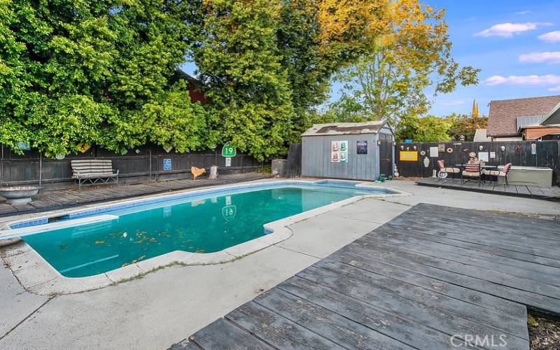 The private backyard will be a favorite entertainment destination with its sparkling in ground pool, wood decks and gated side yards.