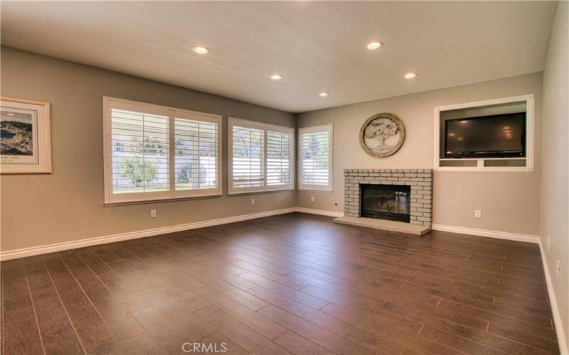 Family room with fireplace adjacent to kitchen