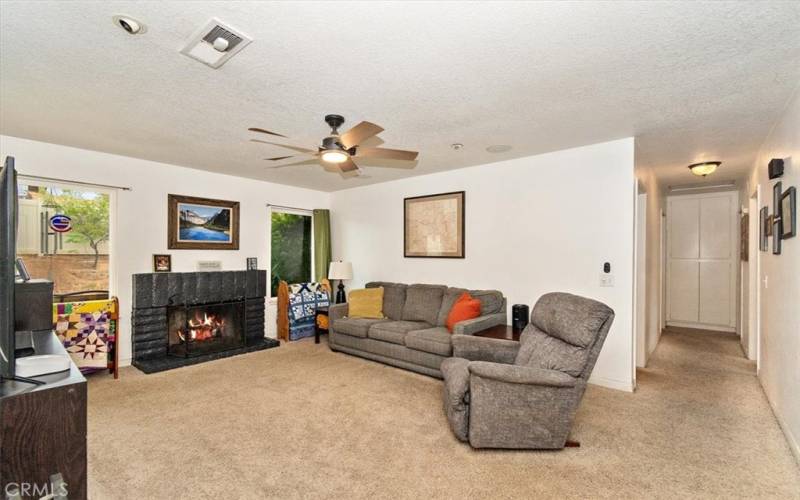 Spacious living room with fireplace and ceiling fAN