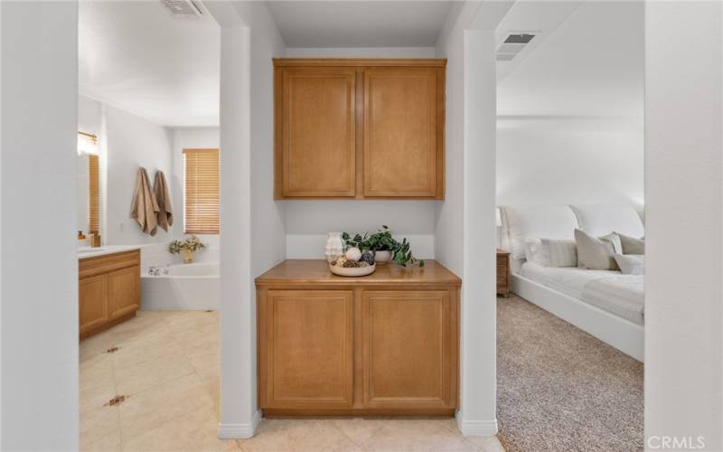 Main floor primary bedroom - linen storage in between the bedroom and bathroom