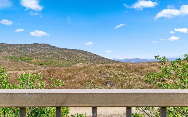 Views of hills behind you and in a distance of the mountains- that come winter are stunning when snow-capped