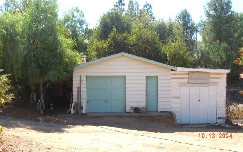 Closer view of the workshop and shed.  There is a small covered carport on the left