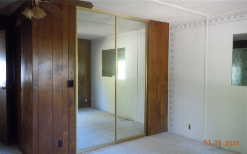 Primary bedroom has mirrored closed doors.