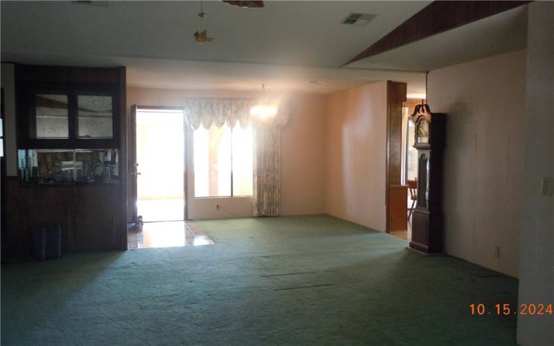 Reverse view of the living room.  Wet bar on the left, bonus area at the right, and the opening leads to the kitchen area.