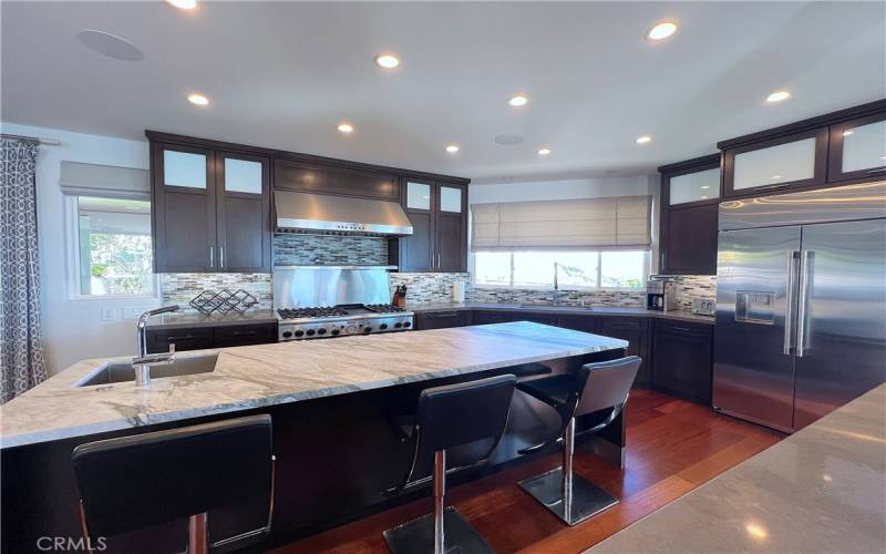 Spacious kitchen with high end stainless steel appliances.