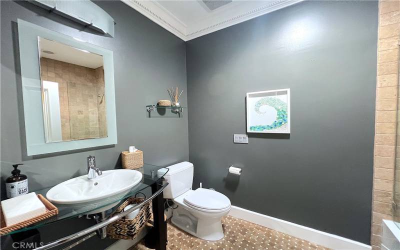 Hallway bathroom with tub and shower.