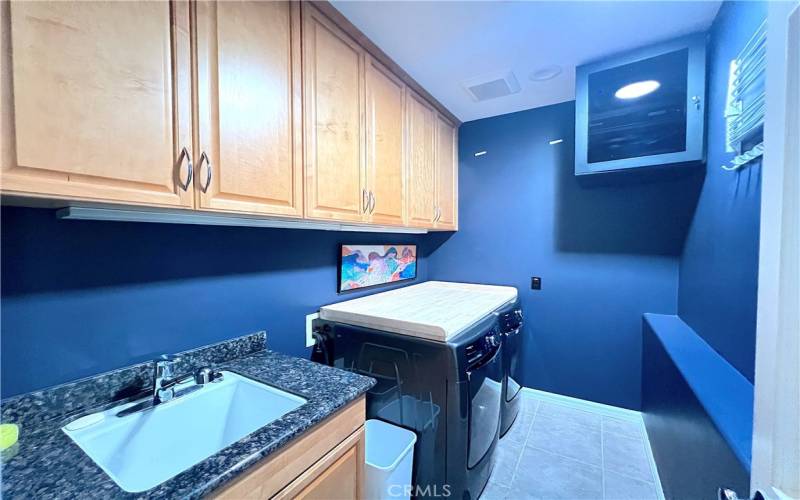 Laundry room conveniently located by the bedrooms.