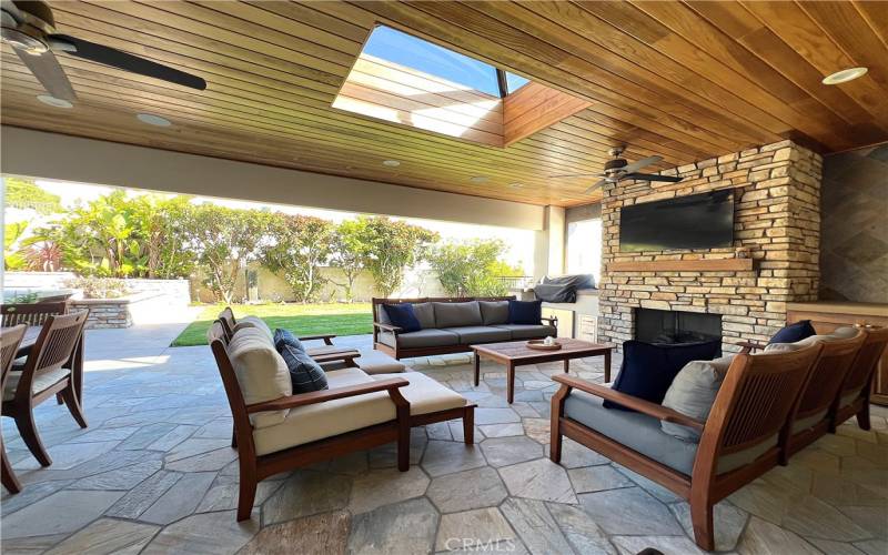 Spacious loggia with large grass area, just off the kitchen complete with grill, fireplace and TV.