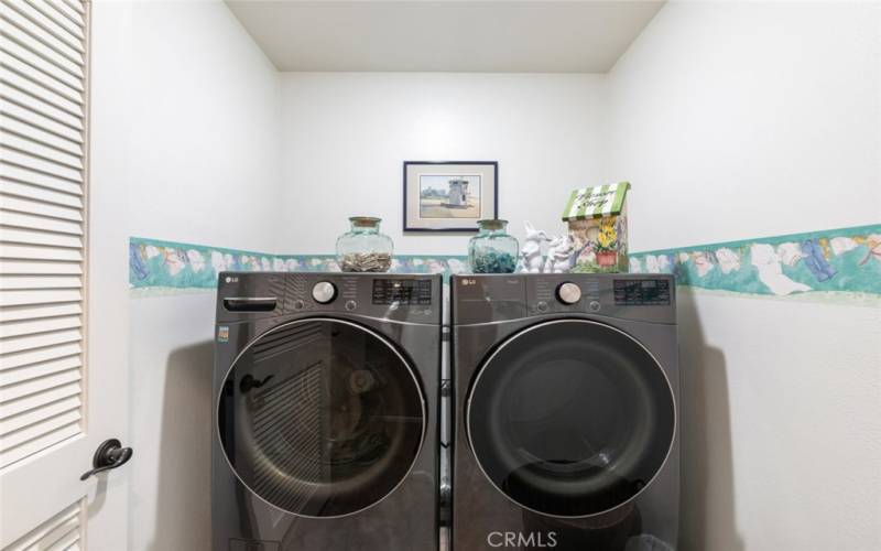 This compact and efficient laundry room provides both functionality and style in a conveniently organized space.