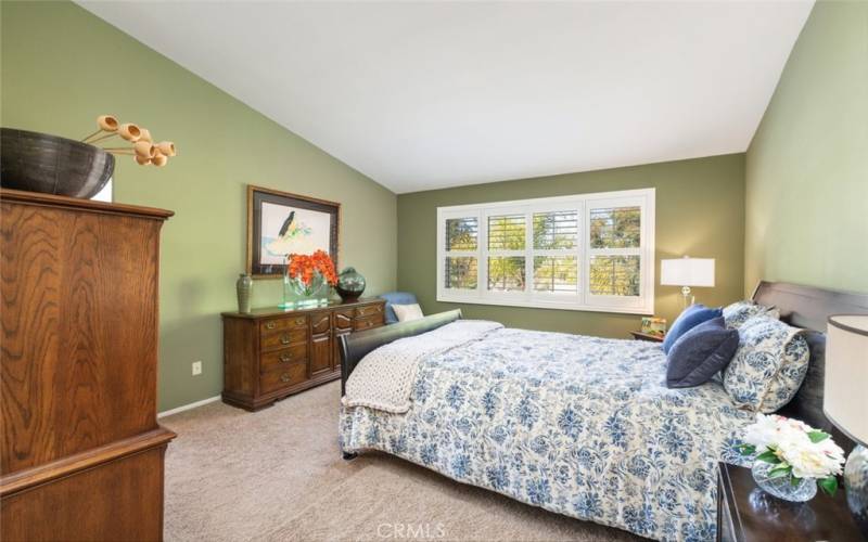 This  spacious primary bedroom has abundant natural light creating a peaceful and comfortable retreat.