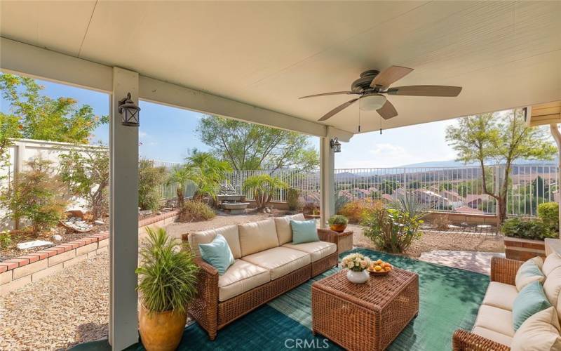 Spacious patio with a shaded pergola, offering breathtaking mountain views and a serene outdoor retreat.