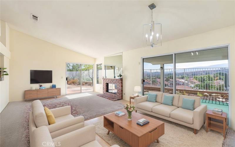 Spacious living room with large windows and sliding doors, offering breathtaking views and abundant natural light.