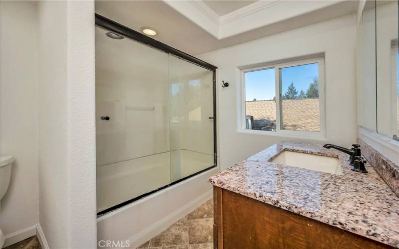 ADU full bath features shower over tub.