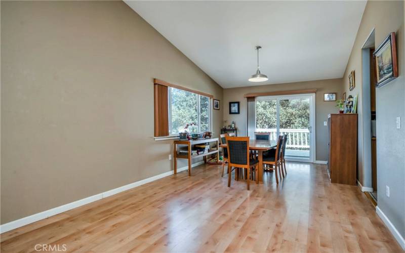 Dining area and living area have a vaulted ceiling for a light, airy effect.