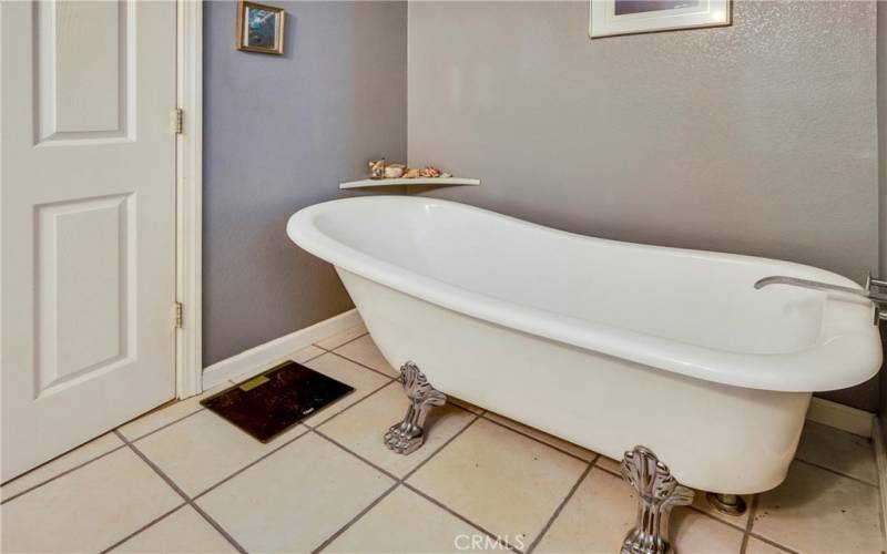 En suite primary bathroom has a separate shower and charming claw foot soaking tub.