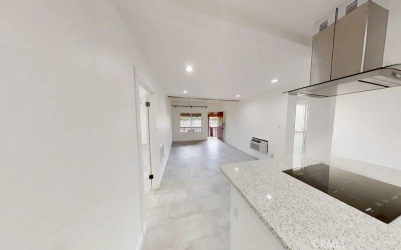 Countertop and wide open living room. Bedroom is the door to the left.