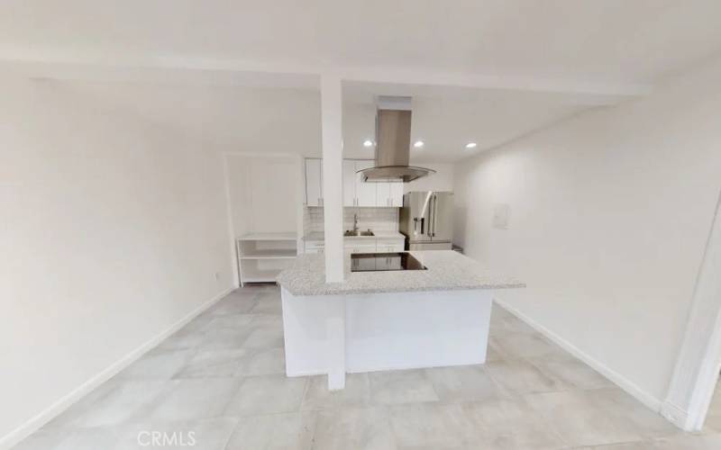 Kitchen with new countertop, and induction stove. refrigerator is included. Owner installed new in unit clothes washer and dryer and countertop dishwasher to the left of the sink after pictures were​​‌​​​​‌​​‌‌​​‌​​​‌‌​​​‌​​‌‌​​‌‌​​‌‌​​​​ taken.