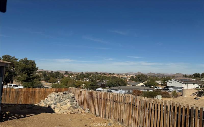 City & mountain views from Master bedroom, small pond in backyard, wood fence.