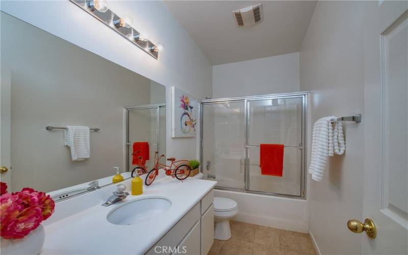 Guest/hall bathroom with tile floors and enclosed tub and shower.