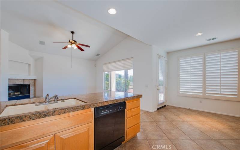 Dinette with tile floors and door to the back yard.