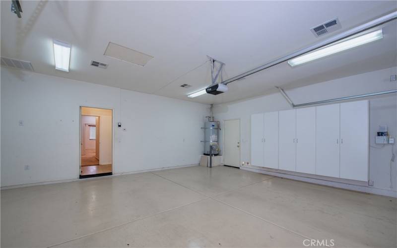 Oversized finished 2-car garage storage cabinets and newer water heater.