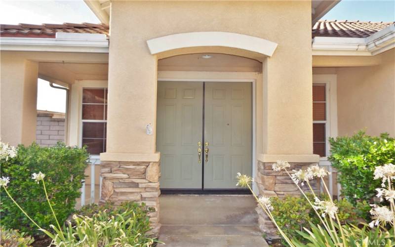 Inviting wrap around covered front porch. Double door entry.