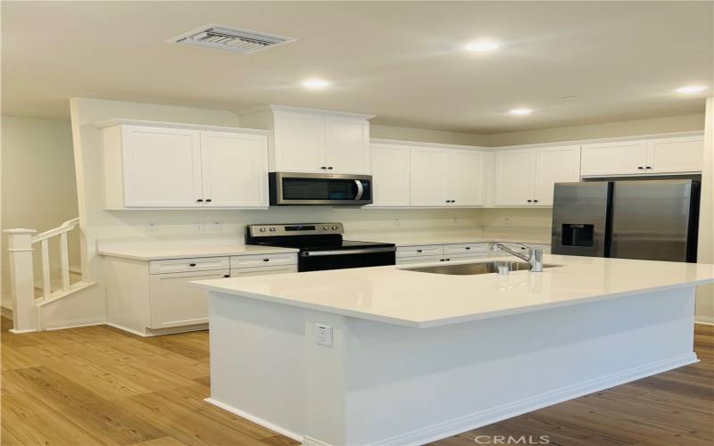 Large kitchenwith quartz counter top and ss appliances