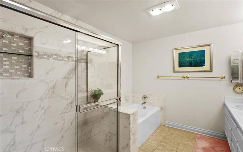 Walking into primary bath you can see the size of the space and separation of tub and shower.