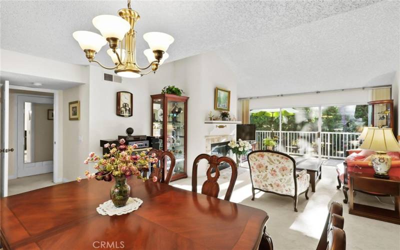 View from dining to living room and out to balcony through sliding glass door