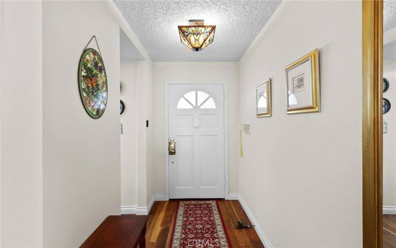 Foyer with stained glass light fixture

 and storage