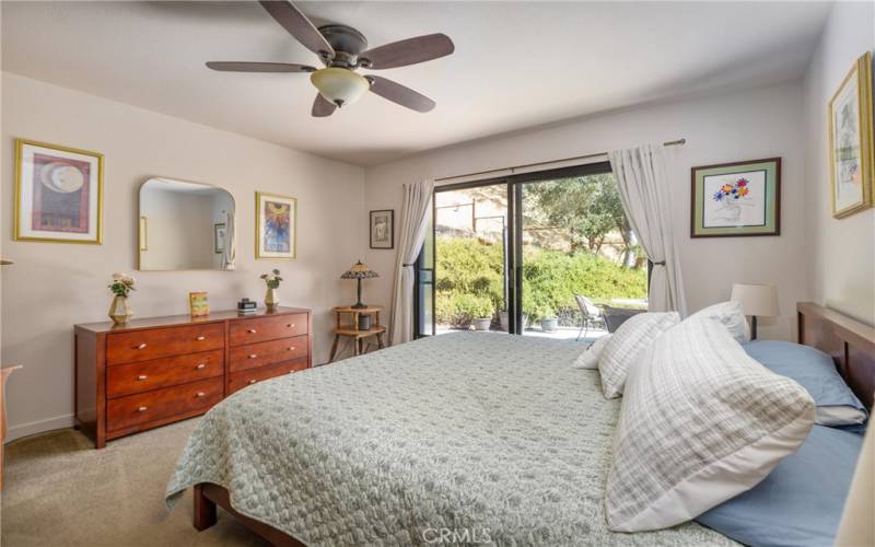 Primary bedroom with sliding glass door to private patio.