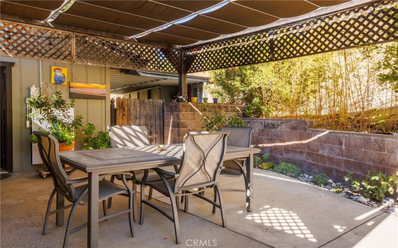 Covered back patio with removable canvas cover and Tesla Power Wall