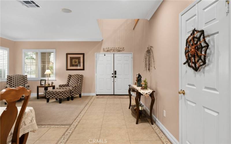 Double doors open to the formal living and dining room