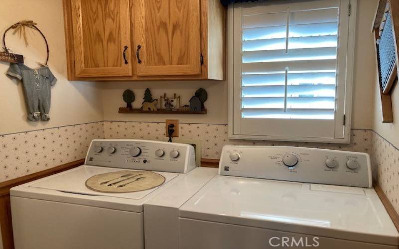 Indoor laundry with cabinets.   Washer and dryer can be included.