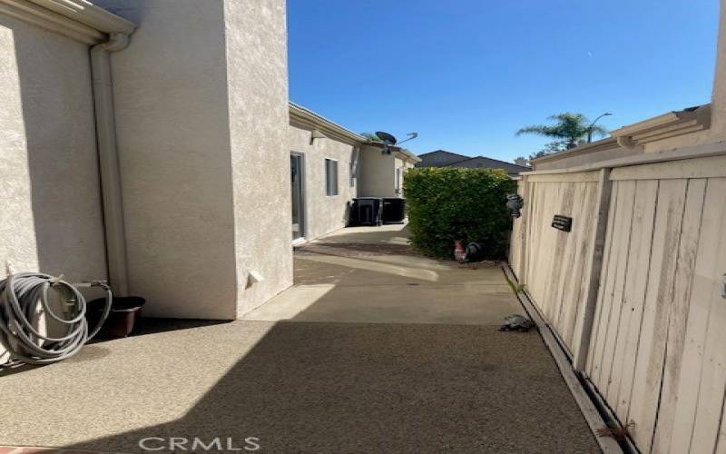 Clean concrete walkways on both sides of the home.