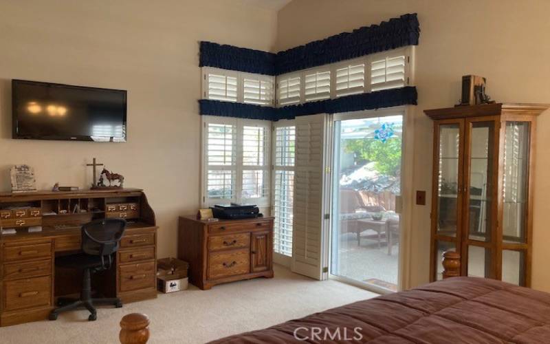 Primary bedroom has room for a desk and a slider to the patio.