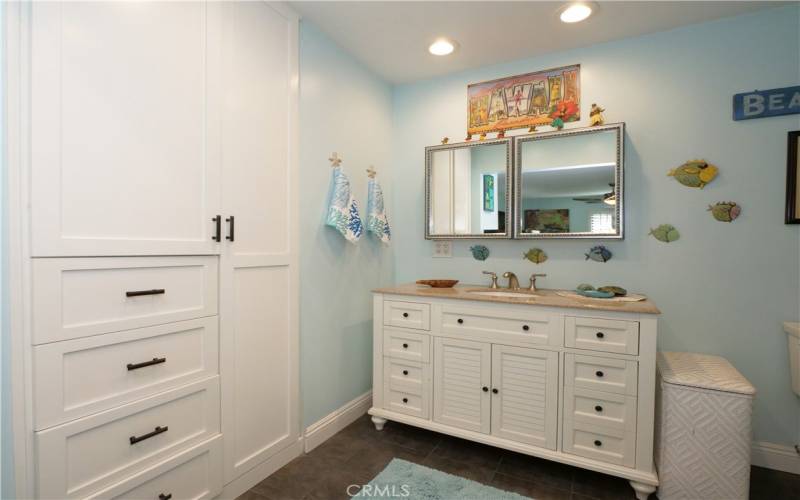 The Primary Bathroom Features Custom Shelving and Drawers for Ample Storage