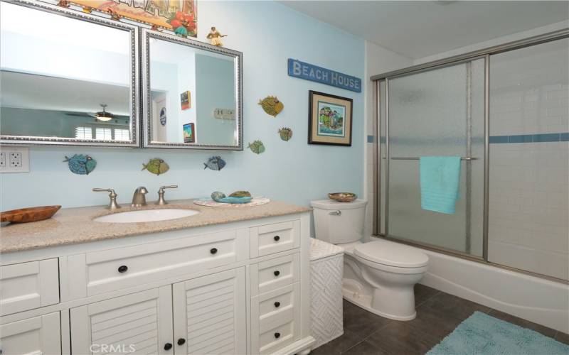 Primary Bathroom Offers a Tiled Bath/Shower and a Porcelain Tub