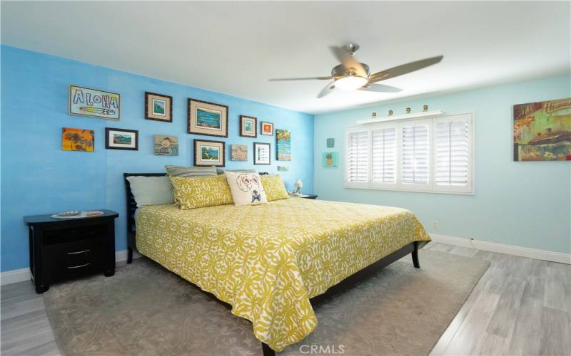 Large Primary Bedroom with Plantation Shutters, Designer Laminate Floors, and Custom Closet