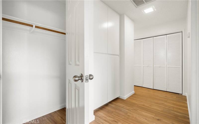 Hallway, storage cabinets, laundry area & Coat Closet