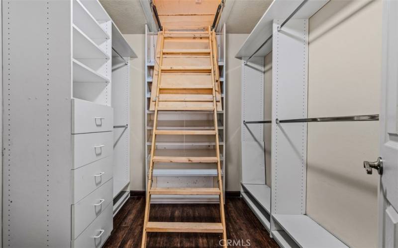 Primary walk in closet with drop down stairs to finished attic