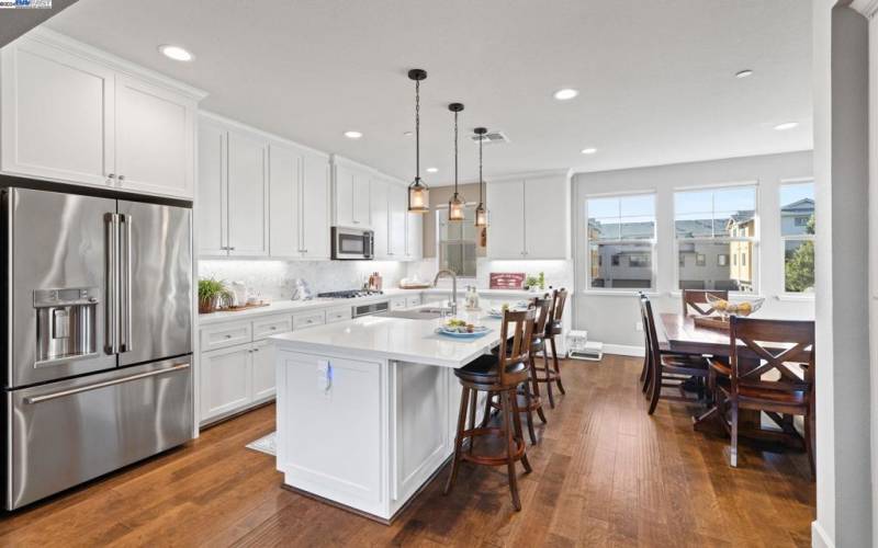 WHITE CABINETS AND LARGE BREAKFAST ISLAND