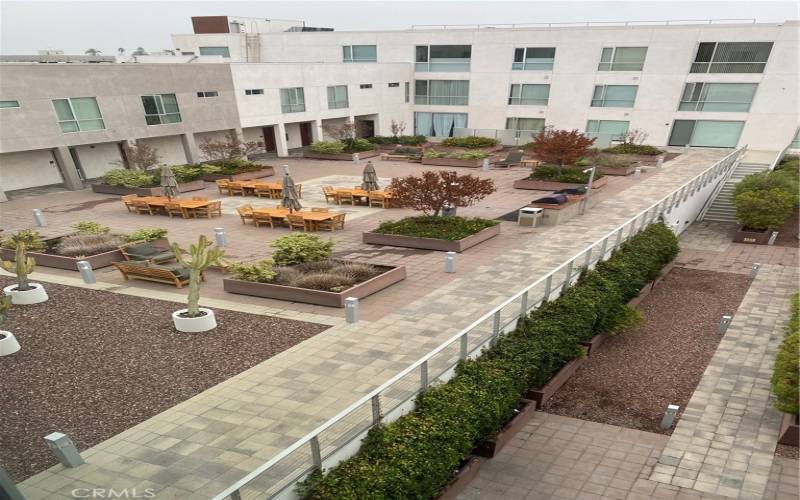 Beautiful Courtyard featuring 2 BBQ's, lounging, dining areas.