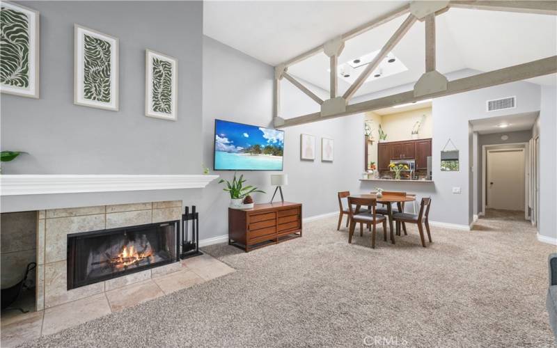 Living room cozy fireplace dining area under sky lights eating bar and kitchen