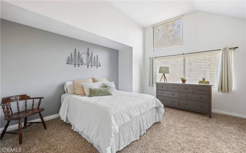 View of Bedroom with high ceilings and large windows view of trees and sky