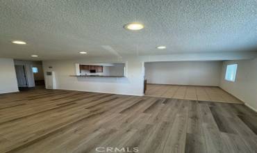 Large living room with new floors. Open counter to kitchen.